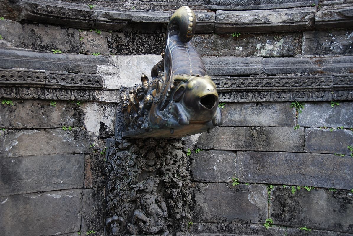 Kathmandu Bhaktapur 05-2 Bhaktapur Durbar Square Naga Pokhari Goats Head Water Spout Water pours from a goats head that protrudes from the mouth of a crocodile demon in the Naga Pokhari in the Palace of 55 Windows in Bhaktapurs Durbar Square.